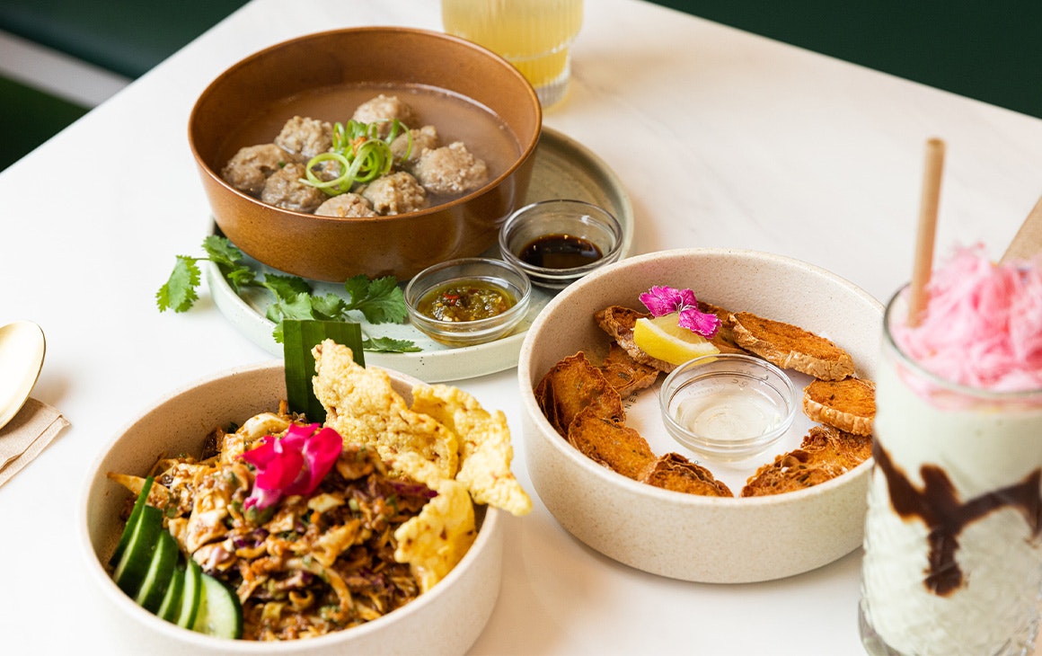 several dishes on a table with a fairyfloss topped drink
